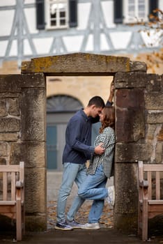 Young Cute Female Hugs Boyfriend. In Autumn Outdoor. Lovers Walking in Park. Attractive Funny Couple. Lovestory in Forest. Man and Woman. Cute Lovers in the Park. Family Concept. Happy Couple.