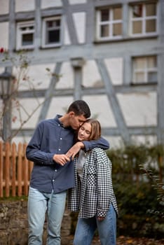 Young Cute Female Hugs Boyfriend. In Autumn Outdoor. Lovers Walking in Park. Attractive Funny Couple. Lovestory in Forest. Man and Woman. Cute Lovers in the Park. Family Concept. Happy Couple.