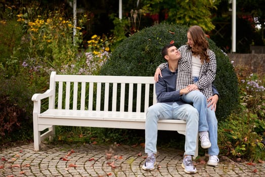 Young Cute Female Hugs Boyfriend. In Autumn Outdoor. Lovers Walking in Park. Attractive Funny Couple. Lovestory in Forest. Man and Woman. Cute Lovers in the Park. Family Concept. Happy Couple.