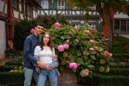 Young Cute Female Hugs Boyfriend. In Autumn Outdoor. Lovers Walking in Park. Attractive Funny Couple. Lovestory in Forest. Man and Woman. Cute Lovers in the Park. Family Concept. Happy Couple.