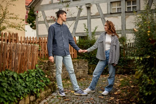 Young Cute Female Hugs Boyfriend. In Autumn Outdoor. Lovers Walking in Park. Attractive Funny Couple. Lovestory in Forest. Man and Woman. Cute Lovers in the Park. Family Concept. Happy Couple.