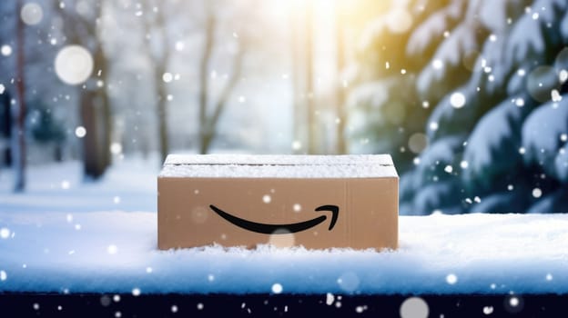 Delivered Amazon prime parcel box on door mat near winter snow entrance. Christmas online shopping. Black Friday sale