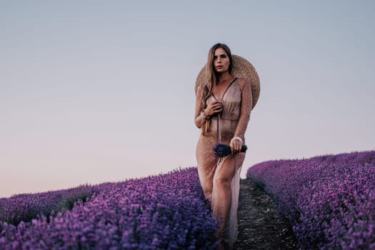 Close up portrait of young beautiful woman in a white dress and a hat is walking in the lavender field and smelling lavender bouquet.