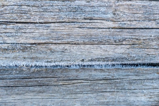 Pale faded brown and cool blue reclaimed wood surface with aged boards lined up. Wooden planks on a wall or floor with grain and texture. Neutral stained vintage wood background.