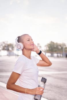 happy young woman listening to music on headphones, concept of rhythm and happiness, copy space for text