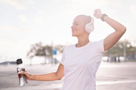 young woman dancing and smiling happy while listening to music in headphones, concept of rhythm and happiness, copy space for text