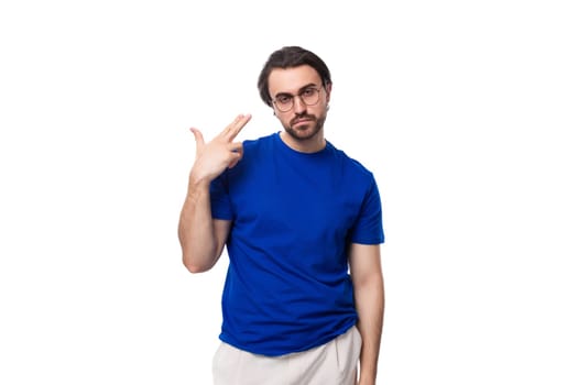 young smart confident caucasian brunette man with a beard in a blue t-shirt on a white background.