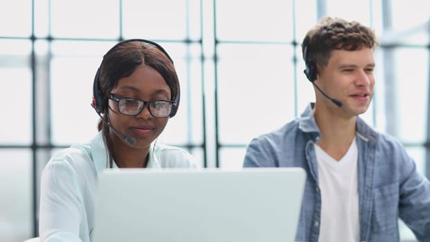 operators woman and man agent with headsets working in a call center.