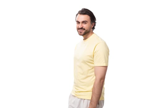 portrait of a handsome young caucasian man with black hair, beard and mustache dressed in a t-shirt.