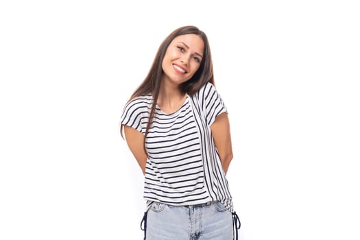 young beautiful caucasian brunette woman in a striped sweater with short sleeves on a white background with copy space.