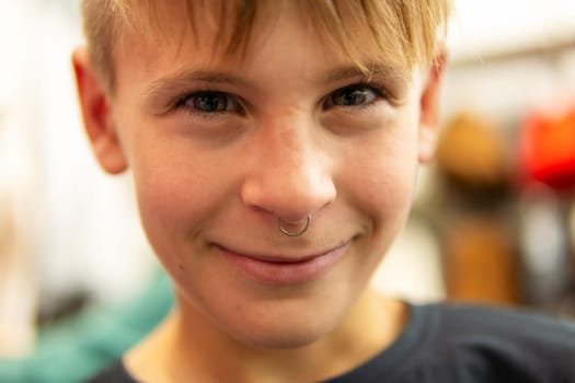 portrait of a smiling teenager with an earring in his nose. High quality photo