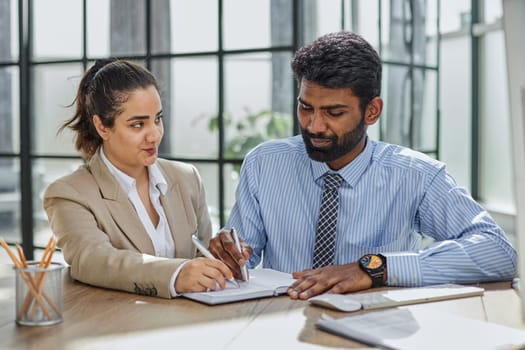 diverse professional colleagues discussing tax financial contract papers working in office at meeting.