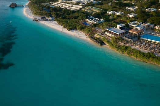 Amazing aerial shot of shoreline and turquoise ocean in zanzibar at sunny day, tanzania.