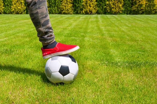 Soccer ball and leg close-up. Sport lifestyle.