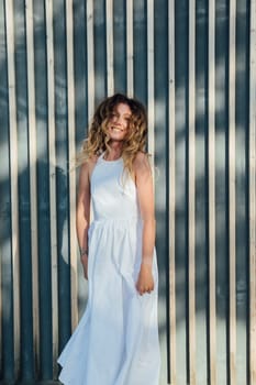 beautiful smiling woman in a summer light dress in the park on a walk