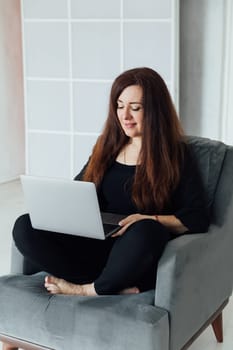 Business woman working online on laptop from home