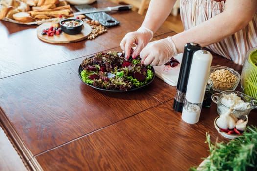 Woman cook at home in kitchen preparing salad for eating