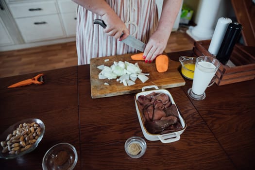 Female in kitchen cooking food from vegetables