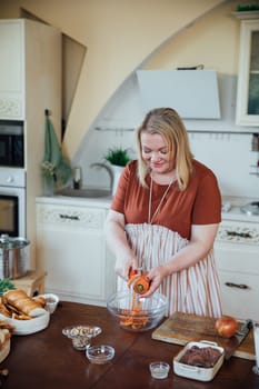 Female in kitchen cooking food from vegetables