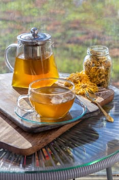 Chinese chrysanthemum flower tea and Dried chrysanthemum flower on wooden cutting board. Healthy beverage for drink. Herbs and medical concept. Space for text, Selective focus.