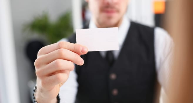 Male hand in suit give blank calling card to female visitor closeup. White collar partners company name exchange executive or ceo introducing at conference product consultant sale clerk concept