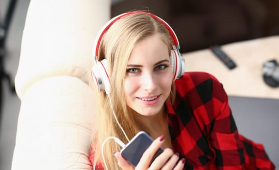 blond young pretty woman listen music headphones dream relax concept