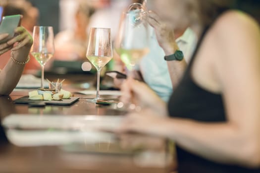 A group of people sitting at a table with wine glasses