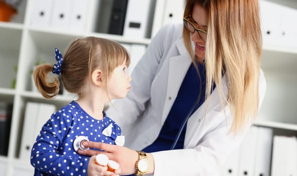 Little child with stethoscope at doctor reception. Physical exam cute infant portrait baby aid healthy lifestyle ward round child sickness specialist clinic test pulse concept