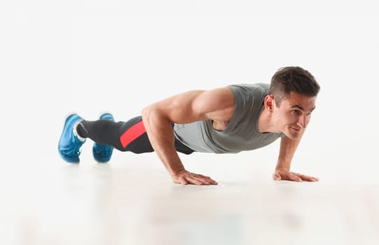 Fitness man wringing from the floor demonstrates good physical exercises isolated on white background healthy lifestyle for many people exercising their own weight for losing for every day push up.