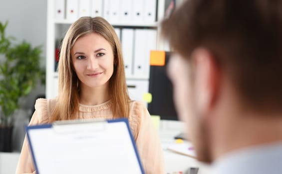 Smiling woman offer contract form on clipboard pad and silver pen to sign closeup. Strike a bargain for profit white collar motivation union decision corporate sale insurance agent concept