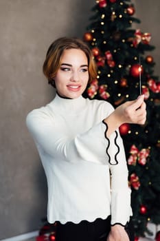 Woman with sparkler celebrates New Year's Eve