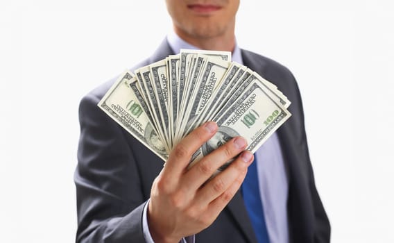 Man in suit and tie hold in arm pack of hundred dollar bills closeup. Stock market exchange earn pile rich present gift employer prepayment service gratitude concept