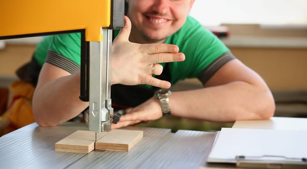 Happy smiling worker wearing yellow hard hat shows four fingers portrait. Manual job workplace DIY inspiration fix shop hard hat industrial education profession career