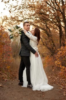 beautiful Wedding couple walking and hugging outdoor on natural background
