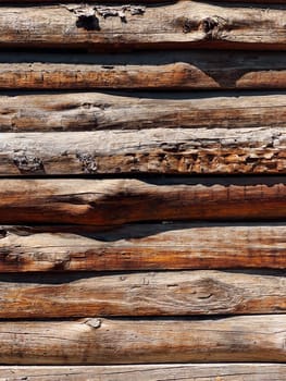 A wall of wooden logs as background