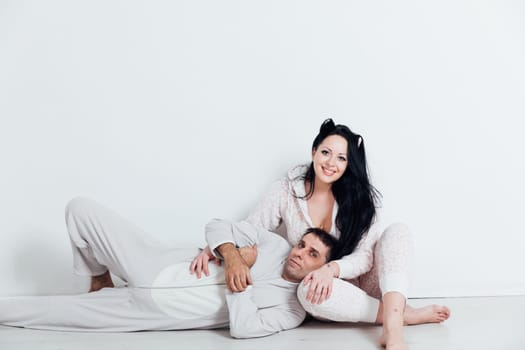 Man and woman in pajamas in the morning in a room in love husband and wife