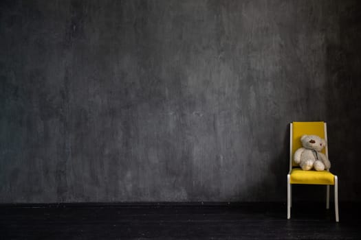 yellow chair in dark grey wall interior