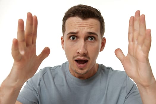 surprised guy looking at camera on white studio background