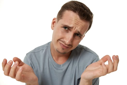 Portrait of offended frustrated young man on white background.