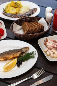 Fried grayling fish on a plate with any appetizers