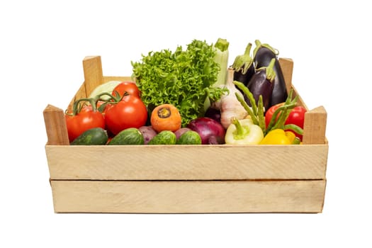 Fresh vegetables in a wooden box isolated on a white background. Eco lifestyle.