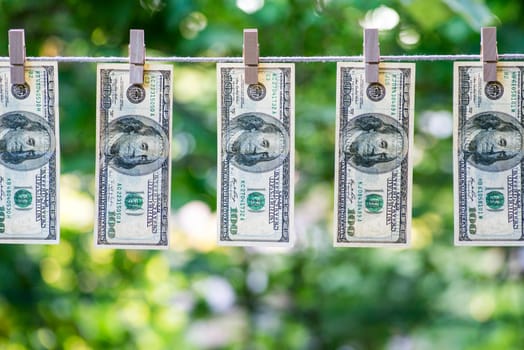 Money Laundering. Money Laundering US dollars hung out to dry. 100 dollar bills hanging on clotheslines
