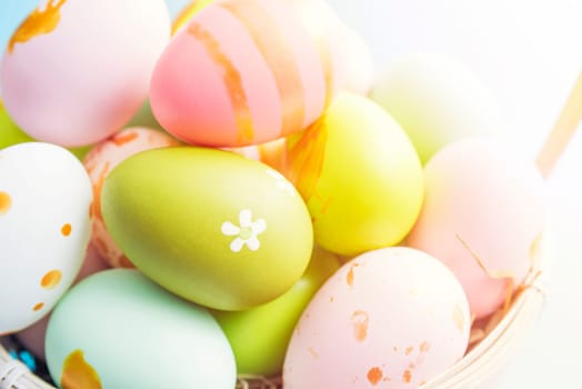 Easter basket filled with painted Easter eggs. Colorful painted Easter eggs in basket.