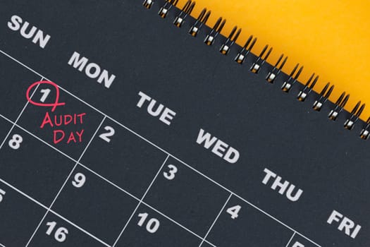 Red circle mark on the calendar at 1 for reminder of Audit Day. Audit concept.