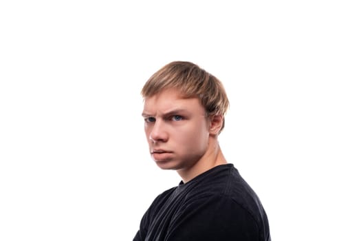 A European teenage boy with brown hair looks suspiciously to the side.