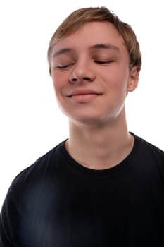 Close-up portrait of a blond 16 year old teenage boy against a background with copy space.