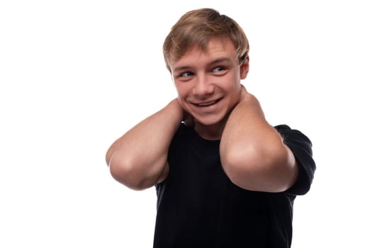 Smart Caucasian fair-haired teenager guy with muscles looks thoughtfully to the side.