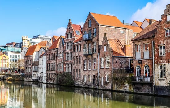 The river and medieval houses of Ghent, a city in the Flemish region of Belgium. Travel concept. High quality photo