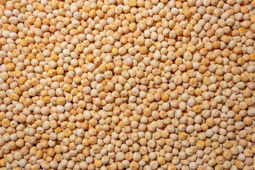 Uncooked Yellow Polished Peas Background. A Culinary Canvas of Dry Yellow Peas, Creating a Lively and Textured Background for Gourmet Cooking. Scattered Raw Polished Peas. Healthy Eating Ingredients
