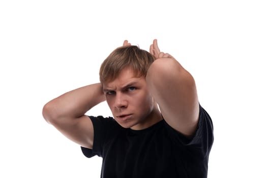 Caucasian guy with blond hair makes a face and horns.